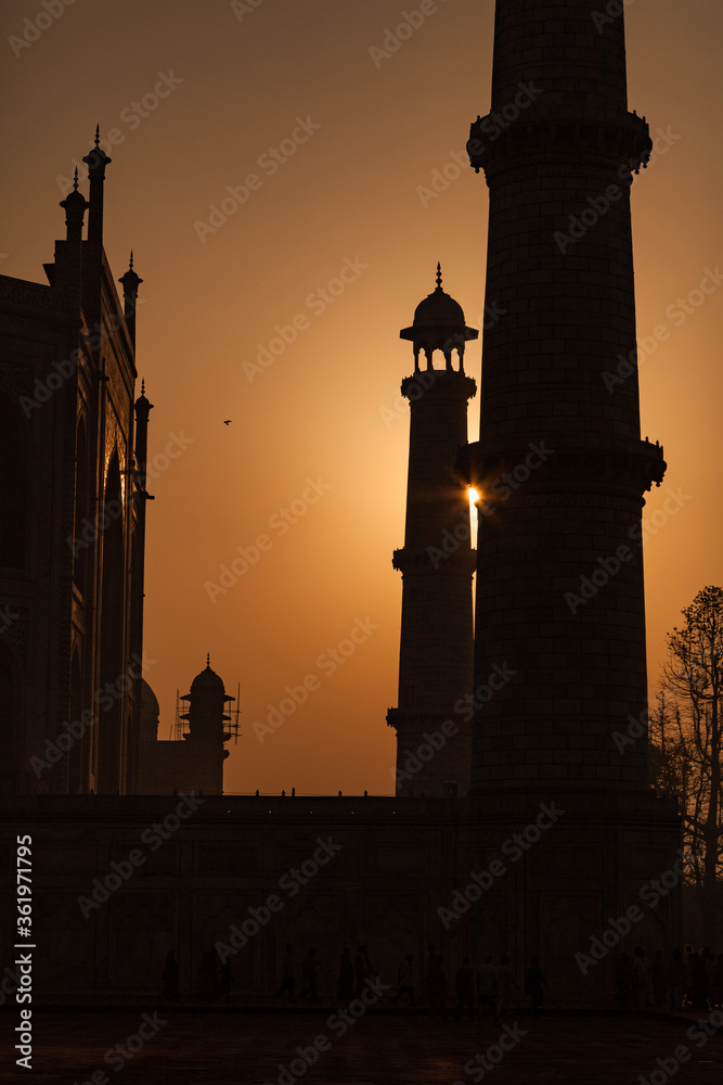 A glimpse of the Sun is visible between two minarets of the Taj mahal during Sunrise in Agra