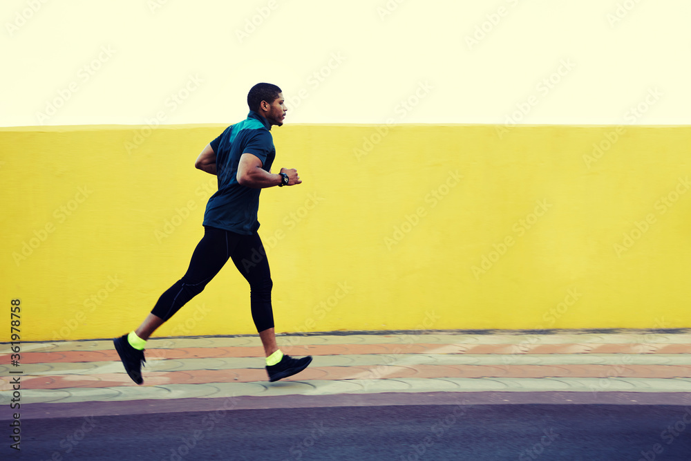 Strong body male runner working out in the city on yellow copy space wall area for your advertising content or text message,afro american man with muscular pumped shape training at evening jog outside Strong body male runner working out in the city on yellow copy space wall area for your advertising content or text message,afro american man with muscular pumped shape training at evening jog outside