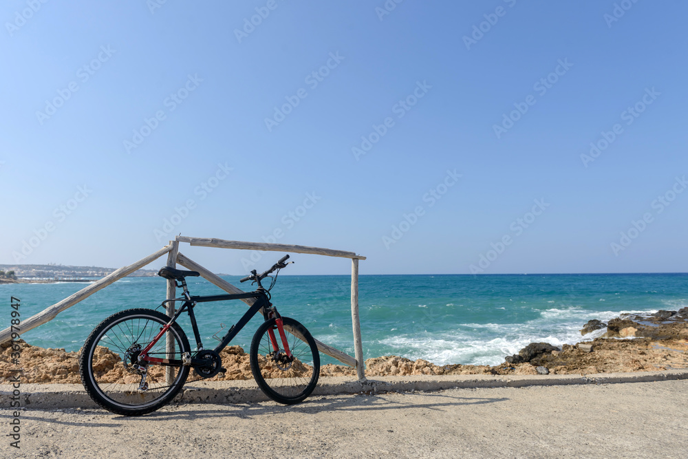 Bicycle parked near the sea standing on the beach. Greece. Велосипед на берегу моря. Bicycle