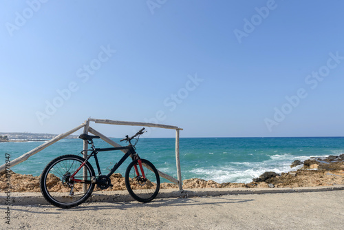 Bicycle parked near the sea standing on the beach. Greece. Велосипед на берегу моря. Bicycle