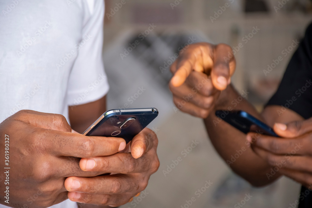 two people sharing content via their mobile phones