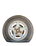 flat tire with rusty alloy wheel on white background. Clipping path