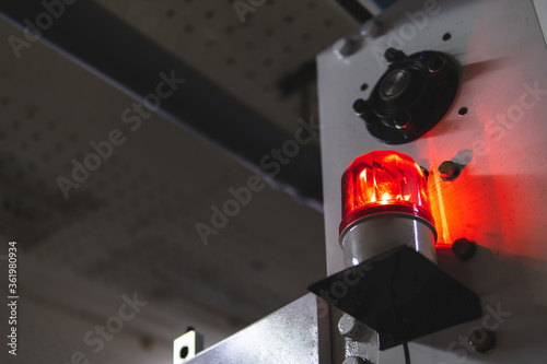 blurred low key Illuminated factory industry red alert emergency light with copy space for background. Attention concept, tragedy, emergency, safety and insurance photo