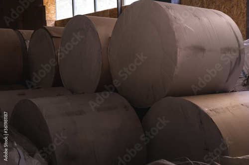 Big Stack of Printing Paper Rolls in Warehouse. The concept of production of paper and paperboard.