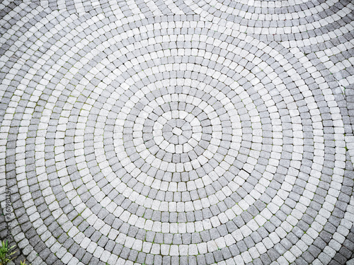 The paving gravel tile is patterned in a circle