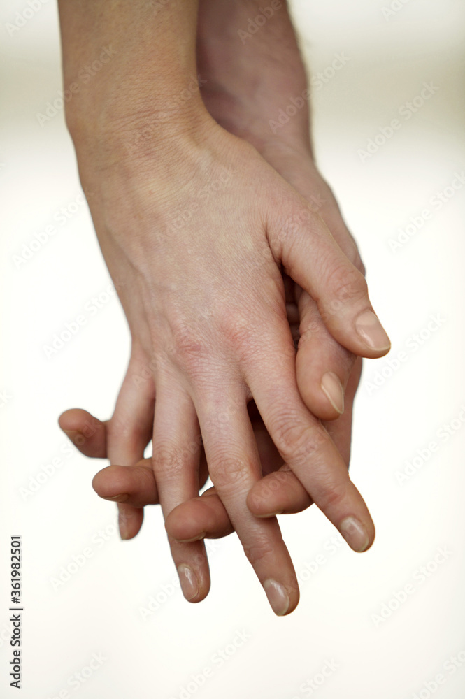 Intimate couple hand in hand