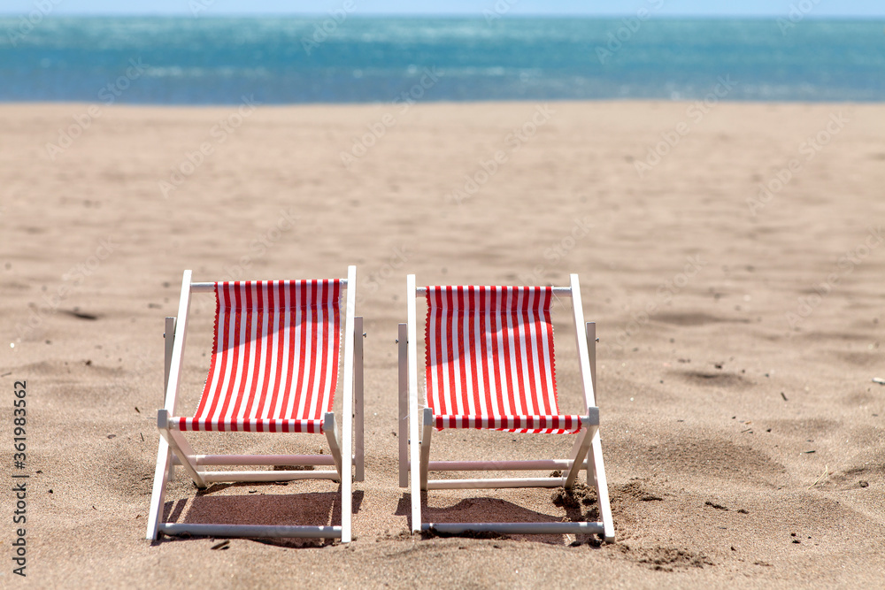 Two beach chairs near the sea on sunny day Two beach chairs near the sea on sunny day