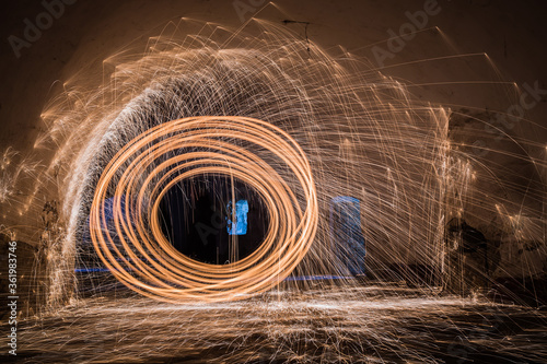 Showers of glowing sparks from spinning steel wool.