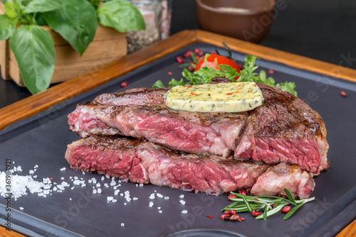 Sliced steak with fresh herbs and vegetables
