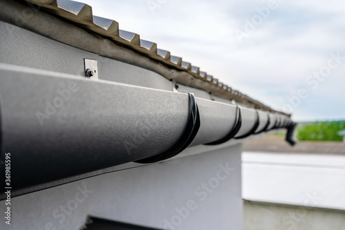 . Gutter system for a metal roof. Holder gutter drainage system on the roof.