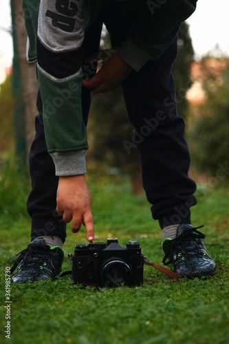 A vintage camera with a kid playing with it 