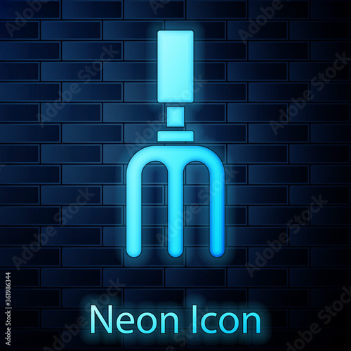 Glowing neon Garden rake icon isolated on brick wall background. Tool for horticulture, agriculture, farming. Ground cultivator. Vector.
