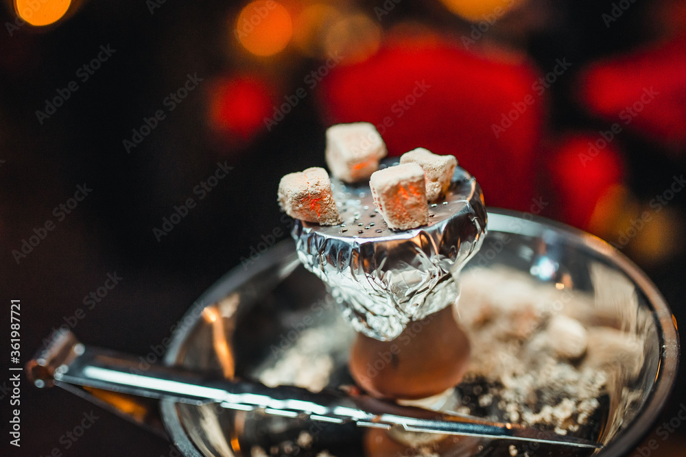 Shisha hookah with red hot coals.