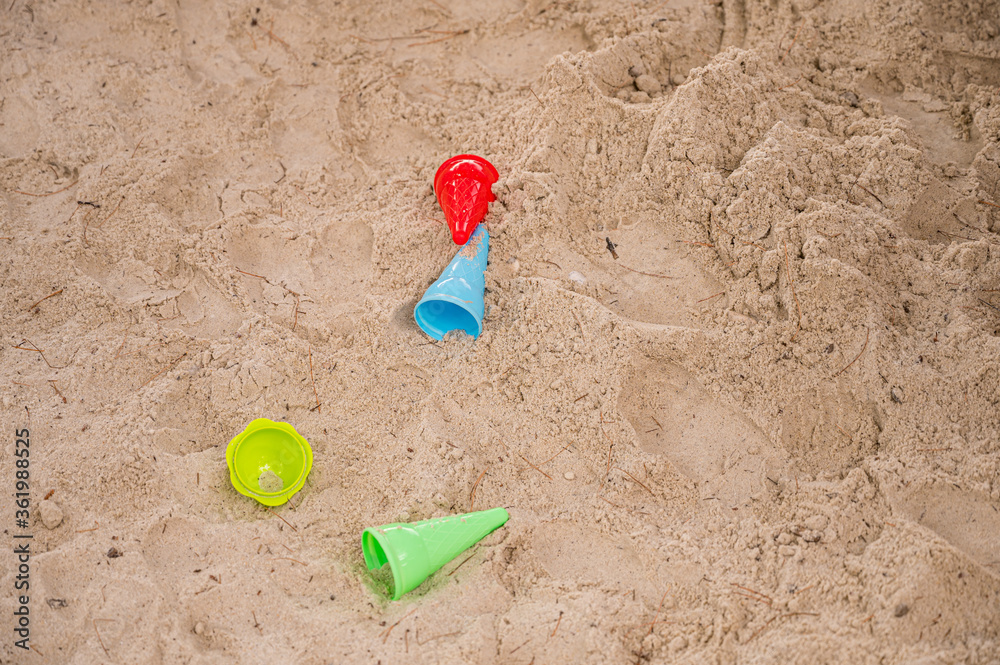 Drop down view of sand toys on beach. Drop down view of sand toys on beach.
