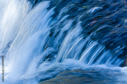 Closeup on descent of small waterfall.