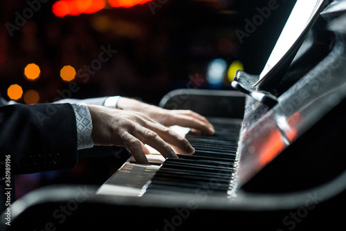 A man plays the piano, close-up of hands. Concert pianist