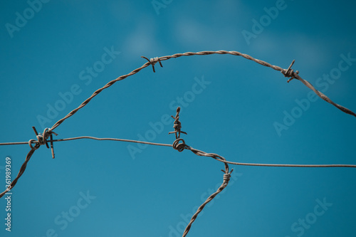 Barbed wire under the clear sky.