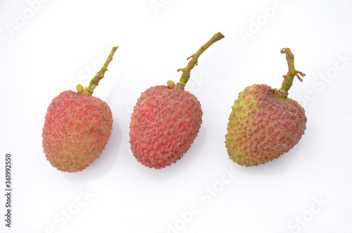 the three red ripe lychee isolated on white background.