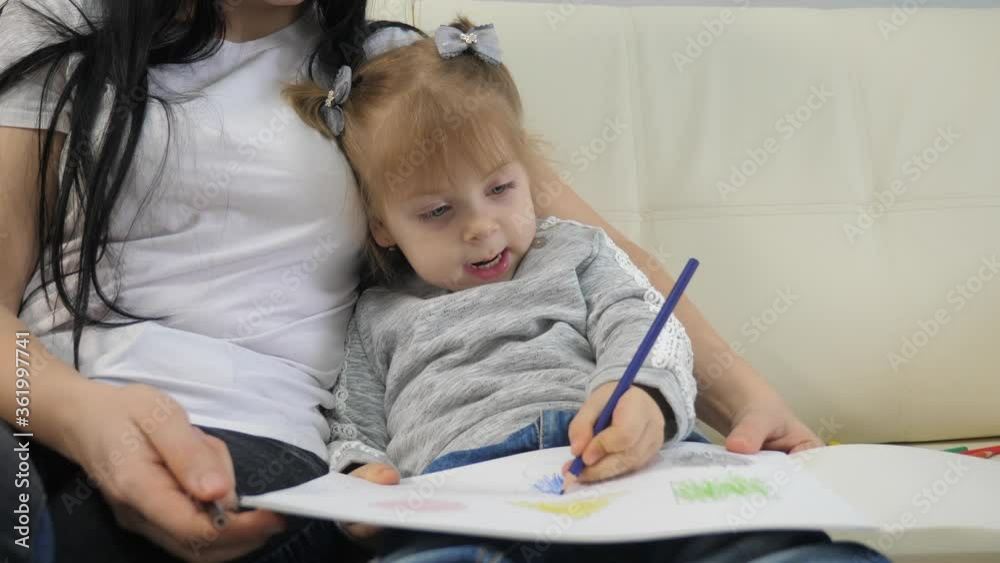 little girl and mom lifestyle draw teamwork happy family concept. child daughter with woman are a engaged in pencil drawing lesson with children development of creativity little girl and mom lifestyle draw teamwork happy family concept. child daughter with woman are a engaged in pencil drawing lesson with children development of creativity
