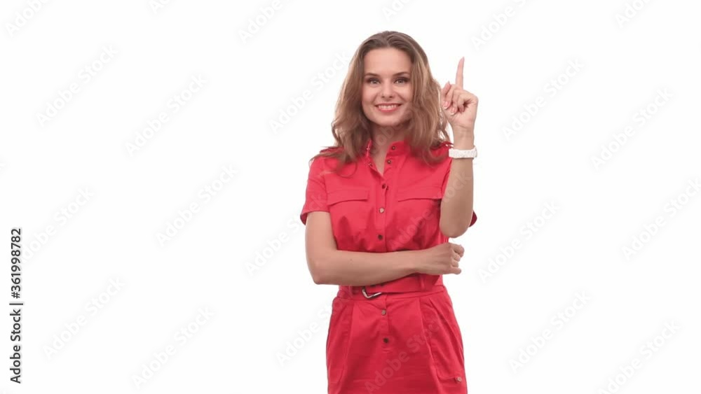 Frustrated girl in a red dress stands on a white background, gesturing that she came up with an idea cheerful emotions on her face. Prores 422. 