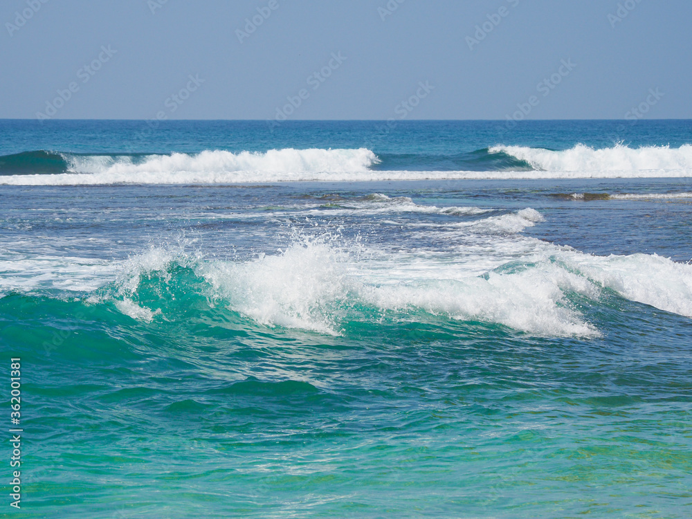 Ocean waves run over the beautiful beach on coast of Sri Lanka, Mirissa. Indian ocean.