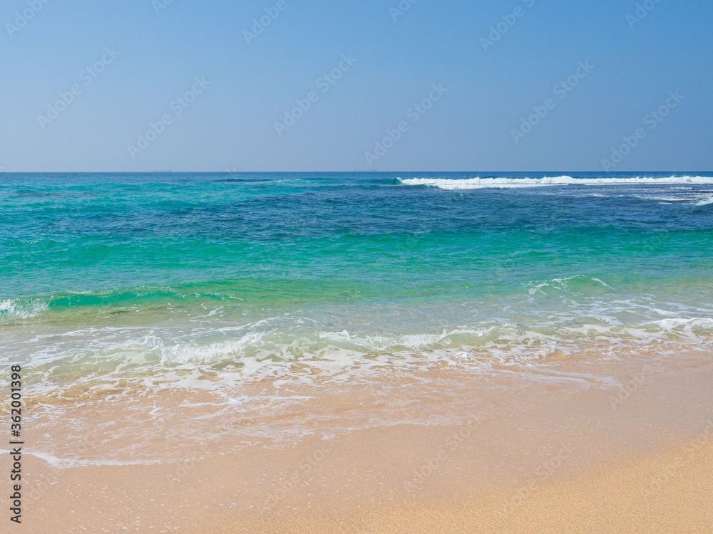 Ocean waves run over the beautiful beach on coast of Sri Lanka, Mirissa. Indian ocean. Ocean waves run over the beautiful beach on coast of Sri Lanka, Mirissa. Indian ocean.
