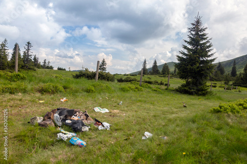 Garbage left on a mountain trail. Stop pollution in the mountains photo