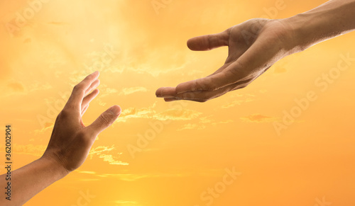 Helping hand concept with sky sunset background