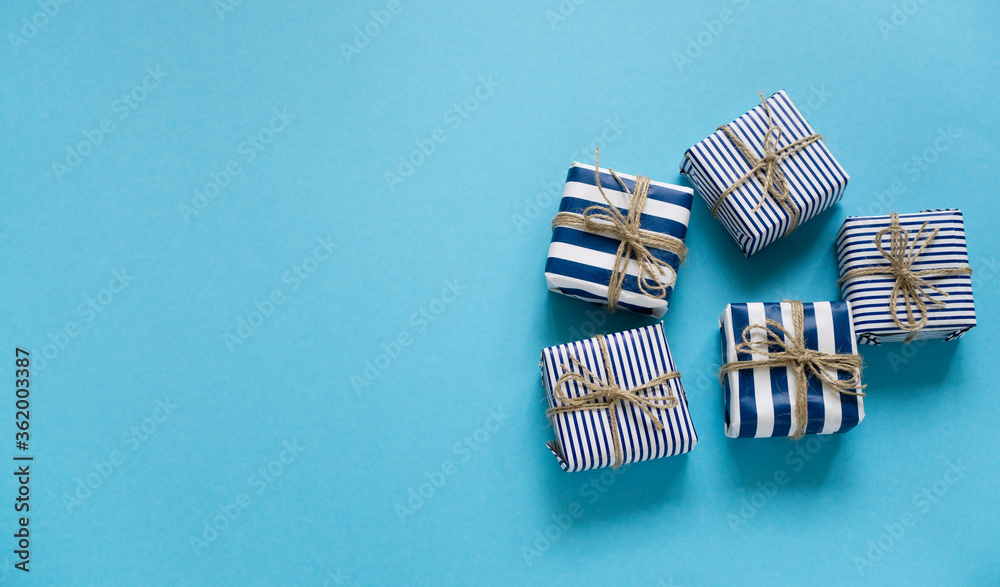 Boxes for fools in a striped festive pair on a blue background with space for text. Birthday or mother's day card Boxes for fools in a striped festive pair on a blue background with space for text. Birthday or mother's day card