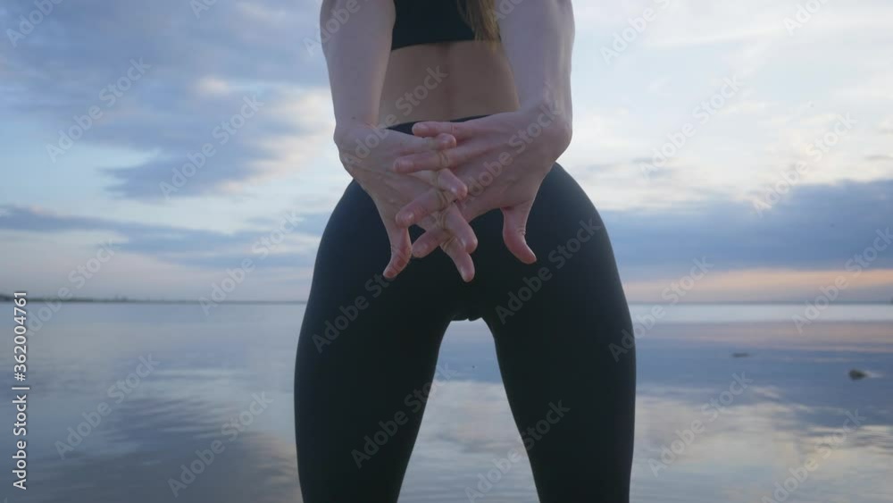 Beautiful young woman doing fitness exercise outdoor. Photo of muscular woman. Fitness and healthy lifestyle concept