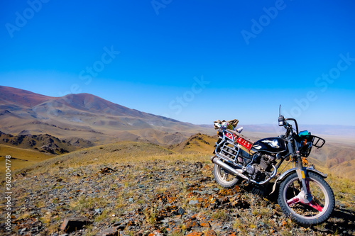 A motorcycle on the peak of the hill in Altai mountain range, Govi-Altai province, Mongolia. 