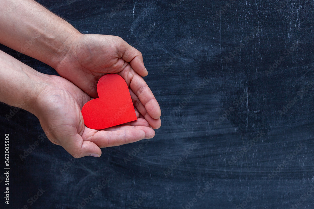 man holding red heart in hands. chalk Board background Stock Photo ...