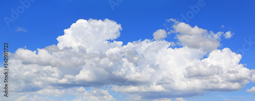 blue sky with white fluffy cloud background