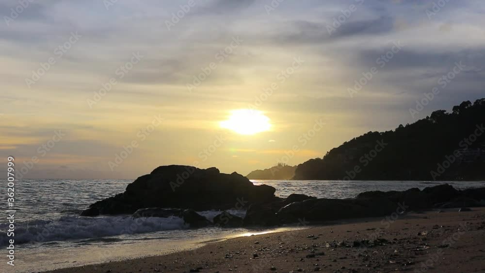 4k sunset on beach with silhouette of rack and mountain at Patong beach, Thailand. 4k sunset on beach with silhouette of rack and mountain at Patong beach, Thailand.
