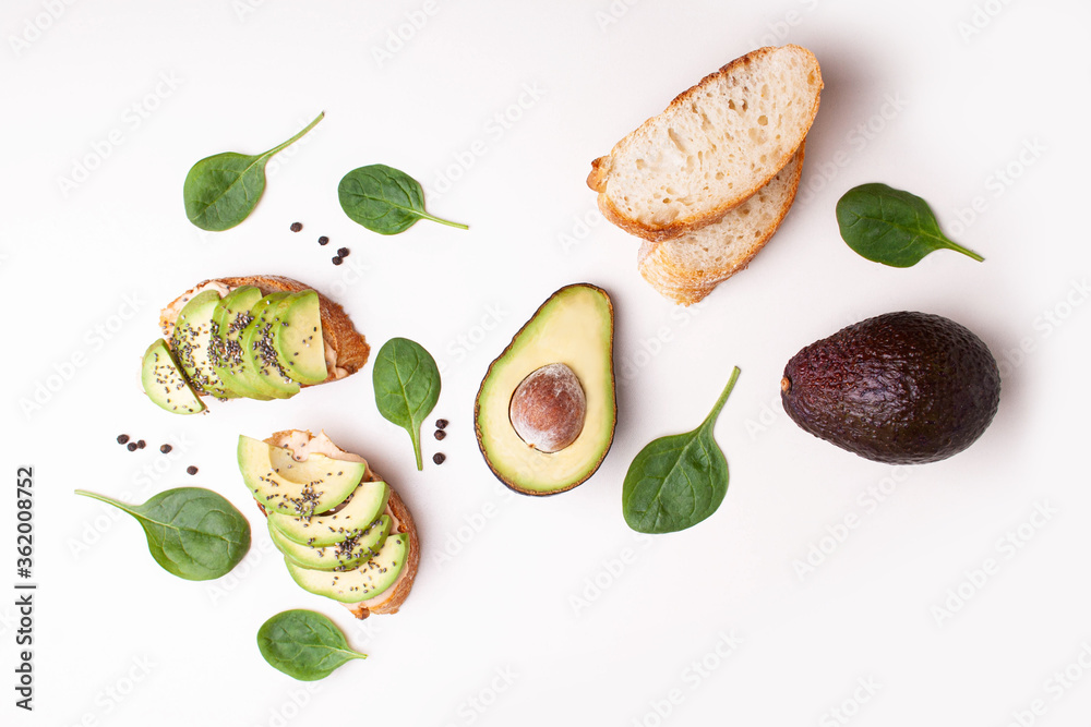 Bruschetta with avocado and baguette on a white table. Flat lay style Bruschetta with avocado and baguette on a white table. Flat lay style