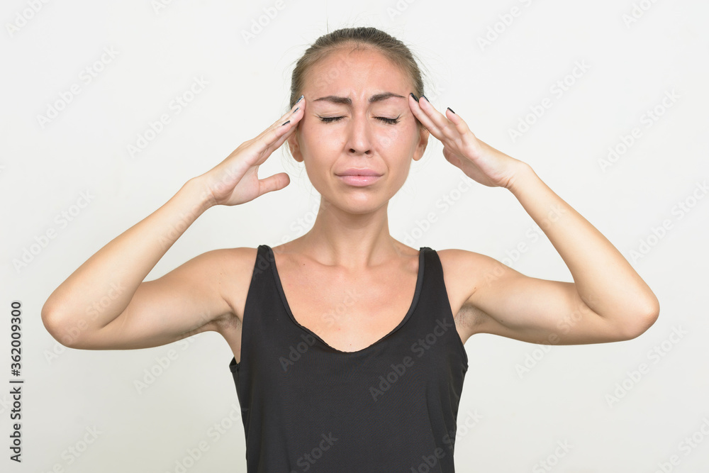Stressed young woman with brown hair having headache Stressed young woman with brown hair having headache