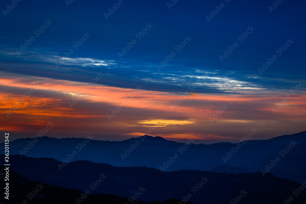 Colorful, vibrant, burning sunset skies, dramatic clouds  Himalayan mountains on Trek to Dalhousie