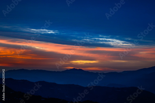 Colorful, vibrant, burning sunset skies, dramatic clouds Himalayan mountains on Trek to Dalhousie