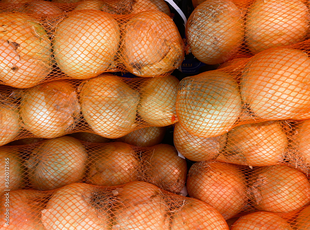 Close up of nets with mild big spanish vegetable onions on german market Close up of nets with mild big spanish vegetable onions on german market