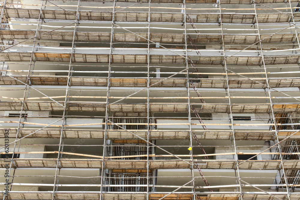 Photo of multistory high rise building with scaffolding