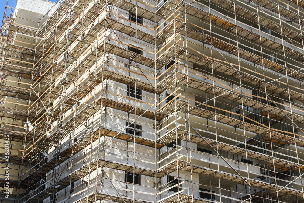 Photo of multistory high rise building with scaffolding