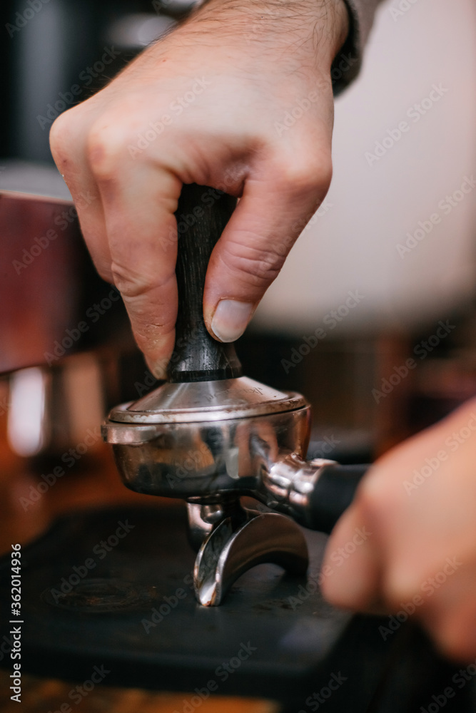hands of a man making a cup of coffee