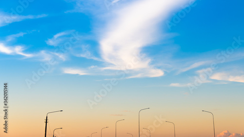 lighting poles on the background of a bright sunset
