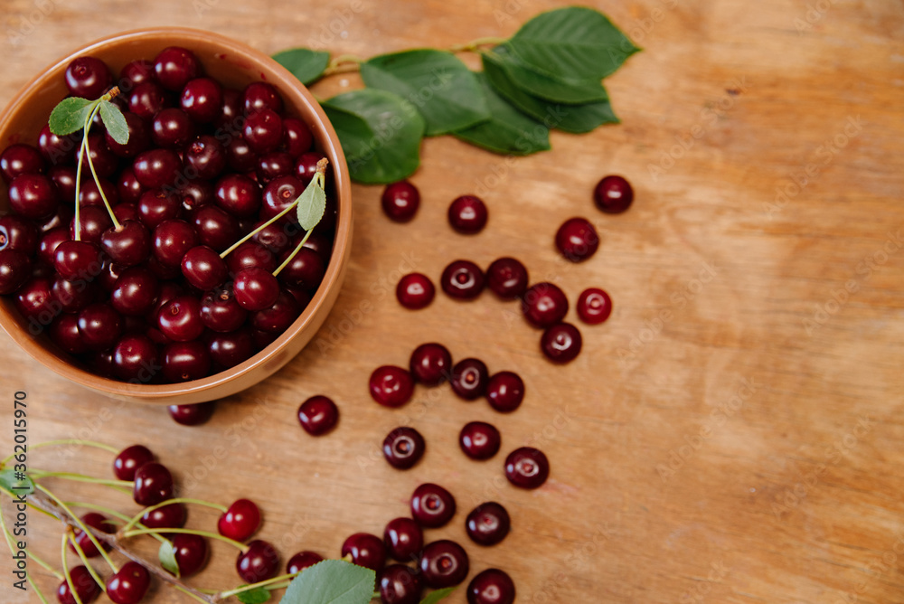 Fresh cherry on plate on wooden background. fresh ripe cherries. sweet cherries. Fresh cherry on plate on wooden background. fresh ripe cherries. sweet cherries.
