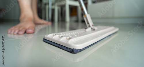 A man cleaning the floor with a mop