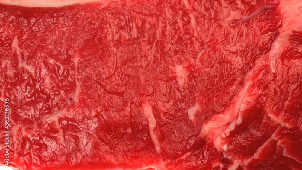 Raw strip-loin steak isolated on white