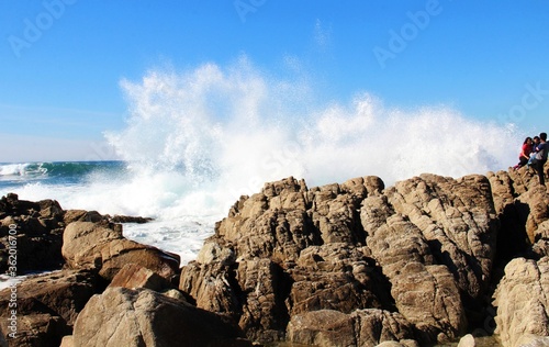 Strong waves splashing on rough rocks