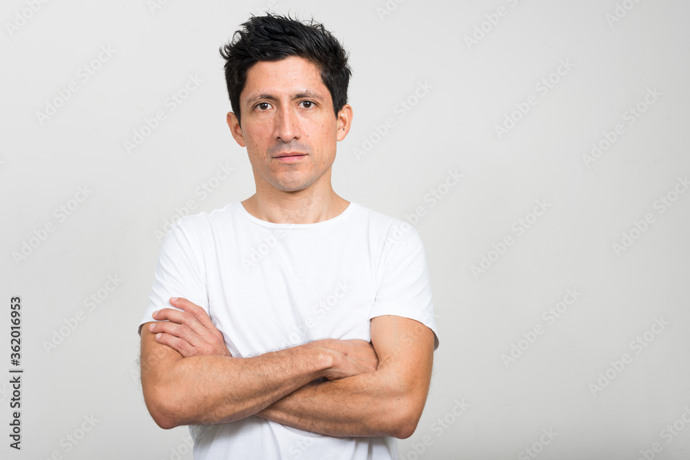 Portrait of Hispanic man with arms crossed