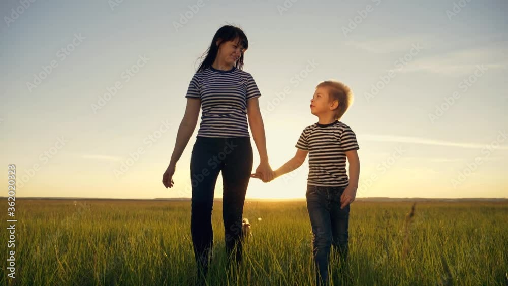 Happy family together.Mother and son walk in the open air in the countryside, lead a healthy lifestyle.The concept of teamwork, family reunion. Happy family together.Mother and son walk in the open air in the countryside, lead a healthy lifestyle.The concept of teamwork, family reunion.