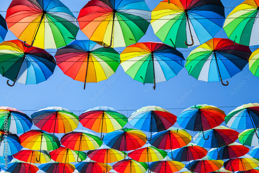 Obraz premium Colorful umbrellas background. Colorful umbrellas in the sky. Street decoration.
